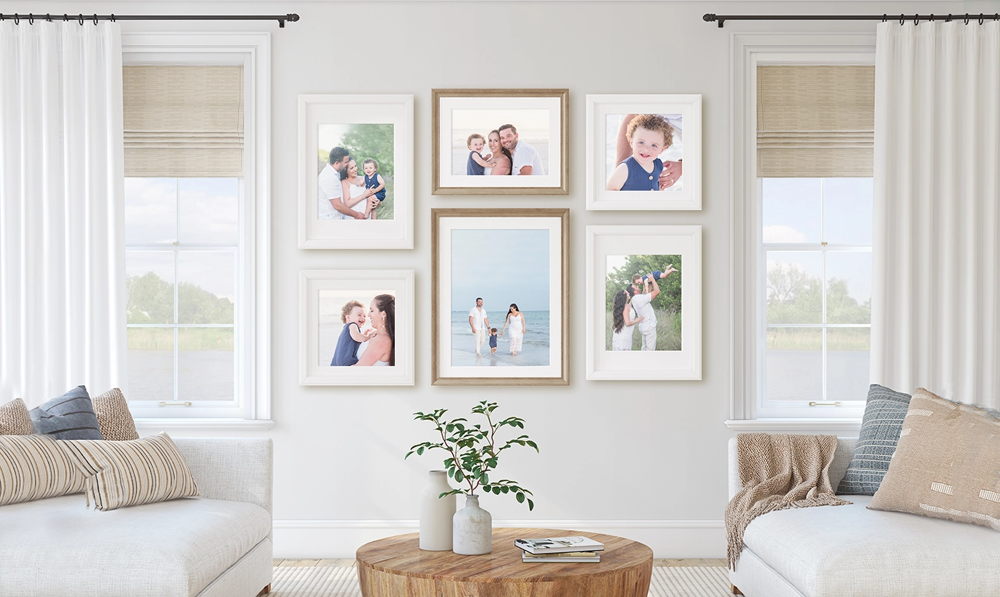 Family photography wall gallery with framed beach session portraits in Sarasota home